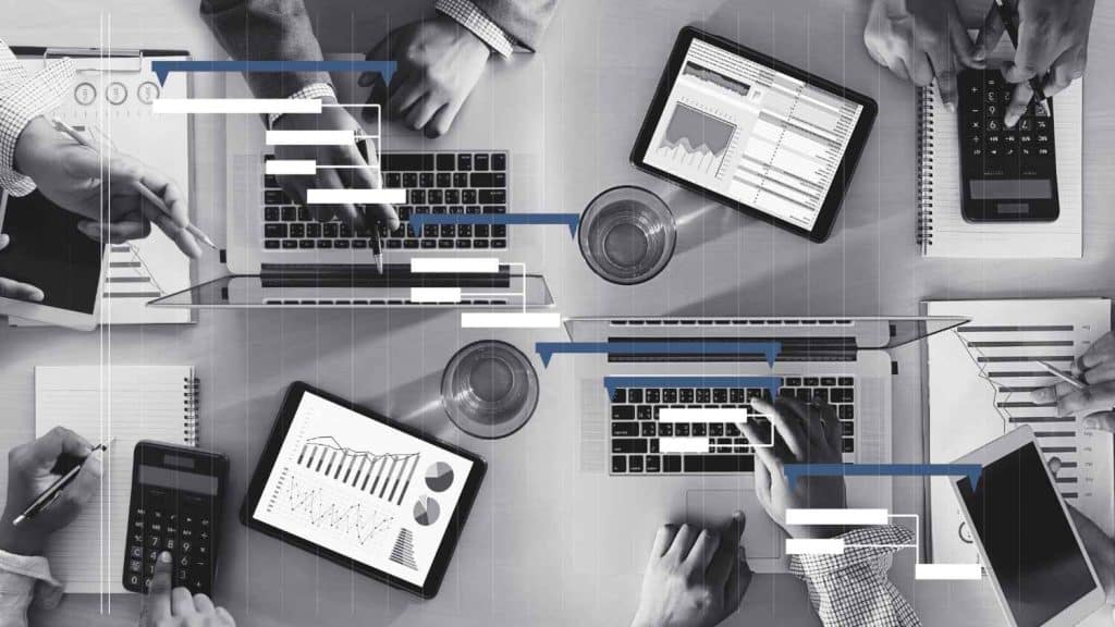 An image of multiple people managing project on their devices