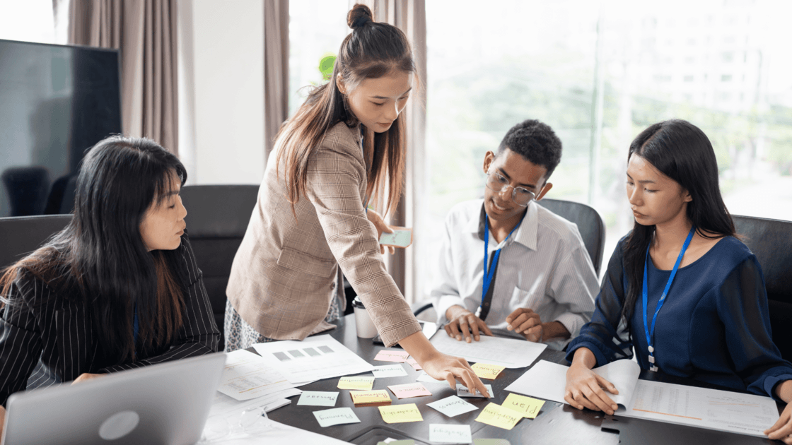 Finance professionals reviewing risk and compliance documents in a meeting