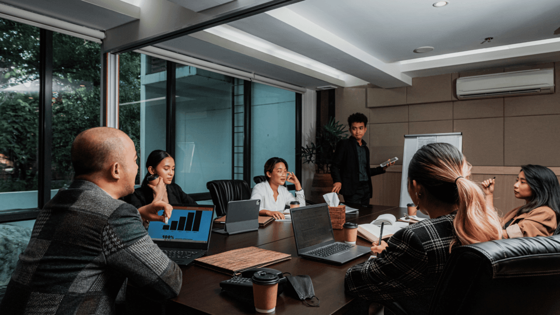 Team leader presenting to colleagues in a leadership meeting room